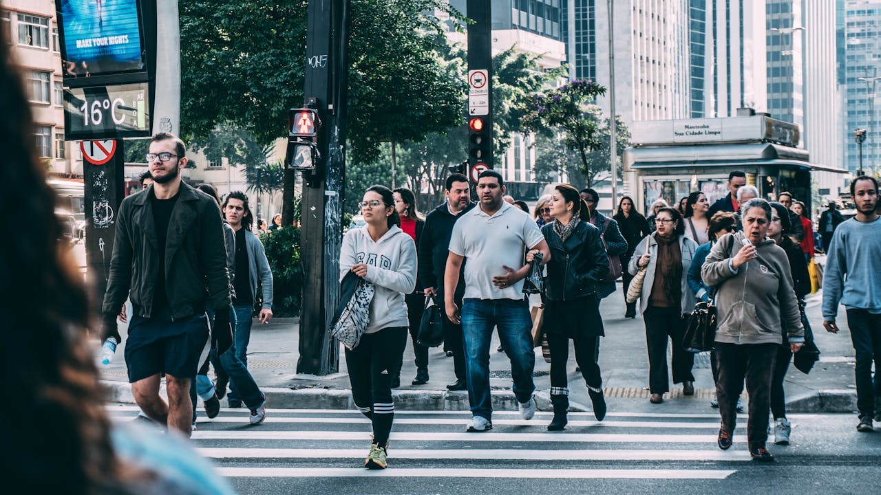 Groups of people walking through city